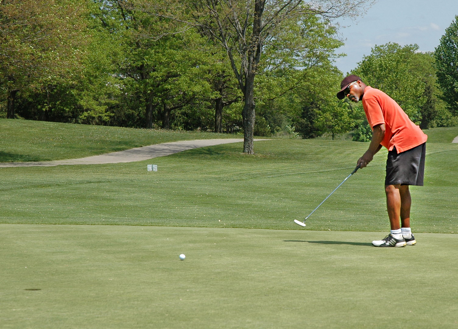 A golfer putting on the 6th green at Blacklick Woods Golf Course
