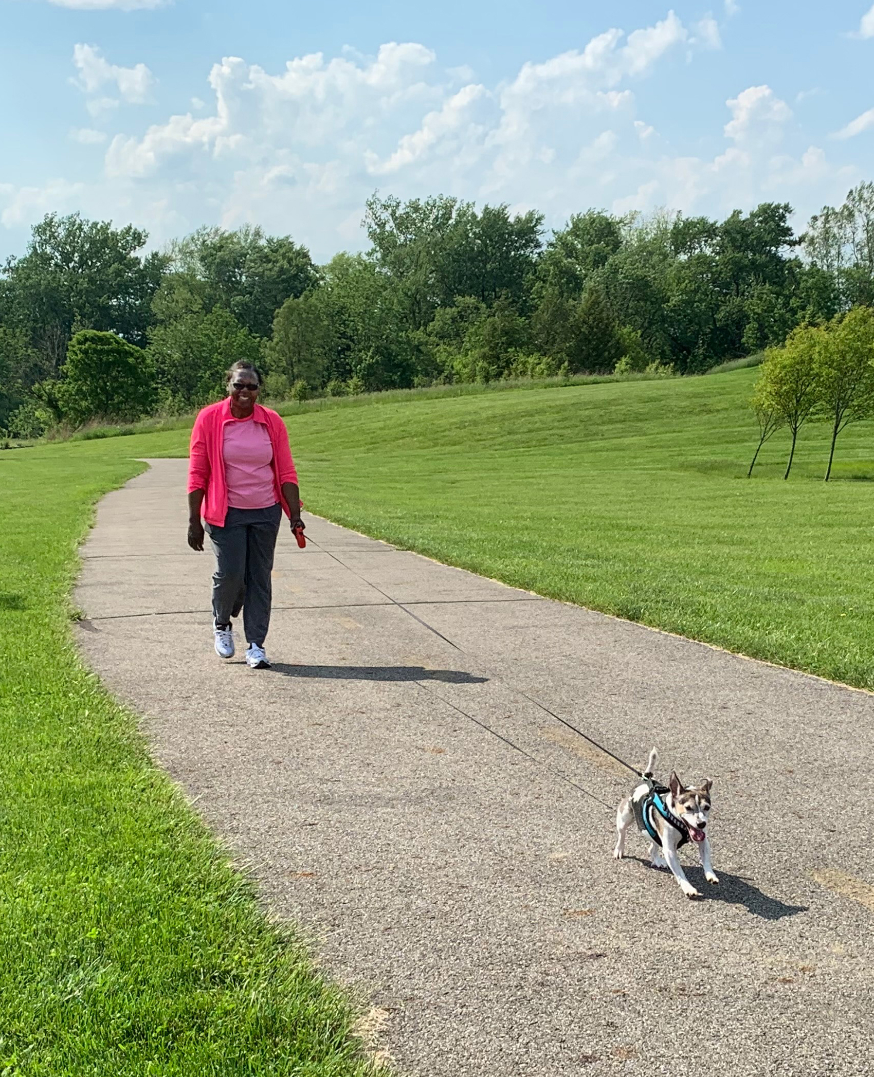Woman walks her dog along the Buckeye Trail at Walnut Woods Metro Park.